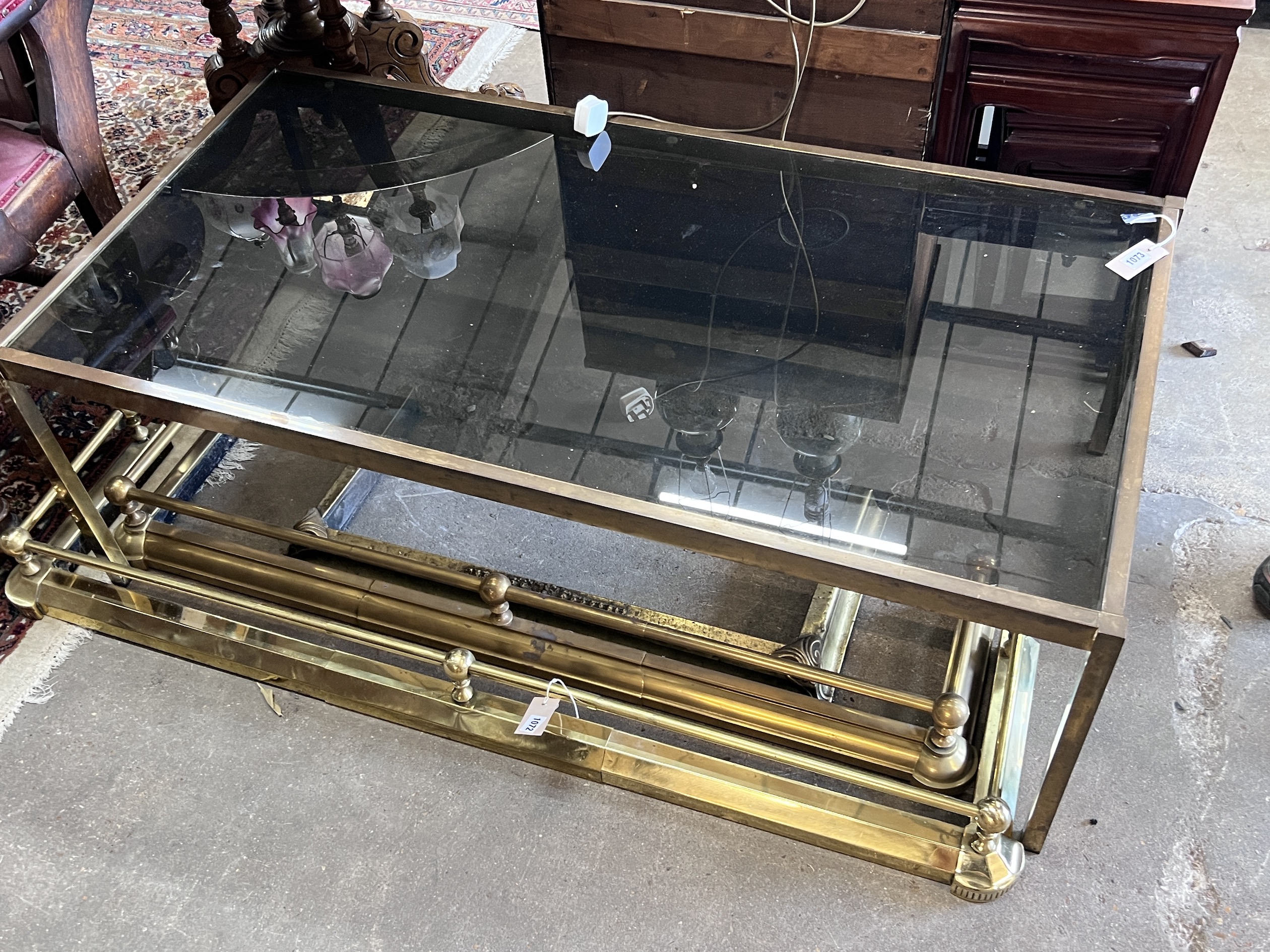 A mid century rectangular brass and smoked glass coffee table, length 135cm, depth 70cm, height 47cm